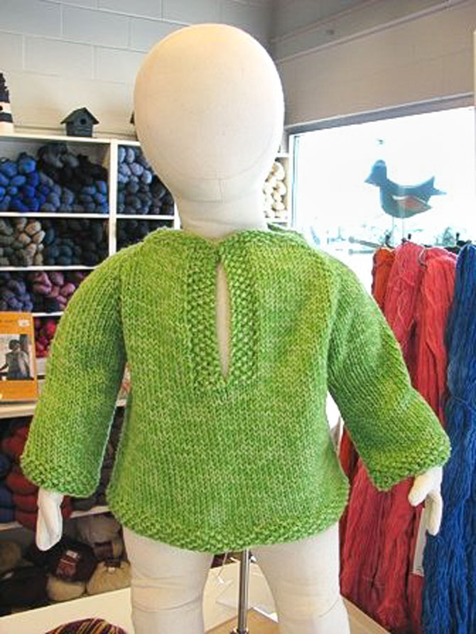 Top-down hand-knit raglan tunic with polo collar neckline.