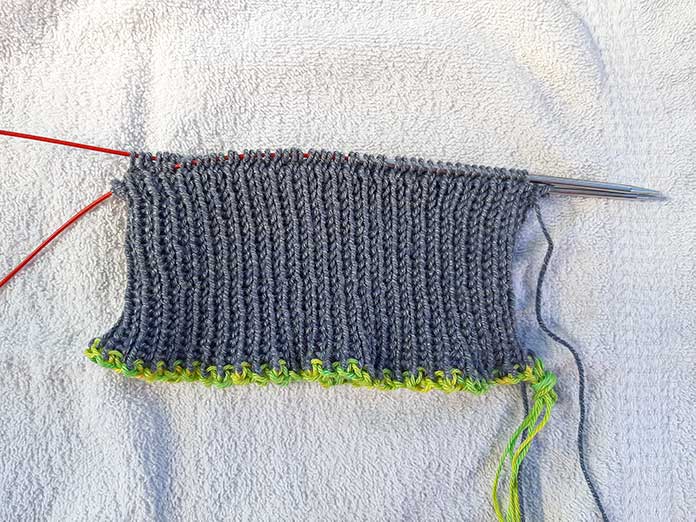 Different cast on methods can be used to start the 1x1 rib with Wool Pop in Graphite.