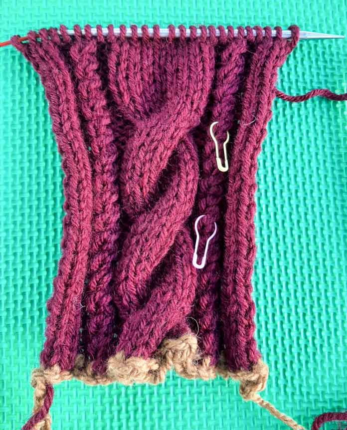 Removable stitch markers make easy work of counting the number of rows in a cable pattern.