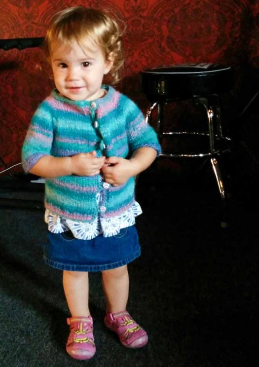 1 year-old wearing a top-down hand-knit cardigan in Classic Shades Metallic