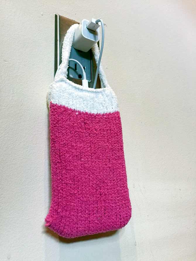 Charger in action! You can hang it from it's own plug, your headboard, night stand, chair. Just tuck the extra cord in behind your phone within the case.