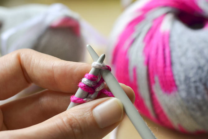 Place the stitch onto the left needle, inserting the left needle through the 'front' of the stitch. (This turns the stitch a little bit).