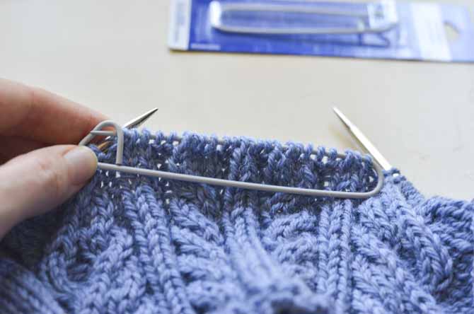 Simply slip the stitches from the needle onto the stitch holder, and then lock it closed.