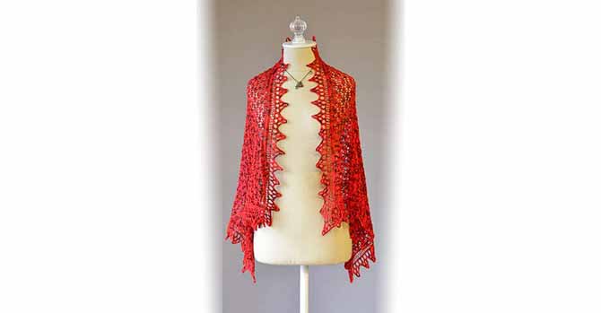 A delicate lace shawl with a triangular lace border made out of red colorway called Cardinal Rule