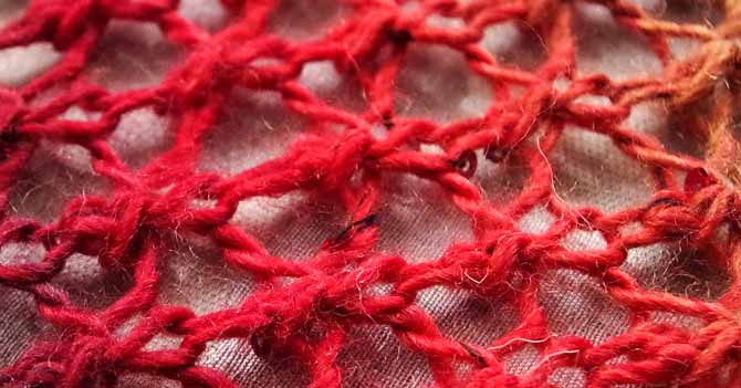 Close-up of lace fabric in coral pink stripe