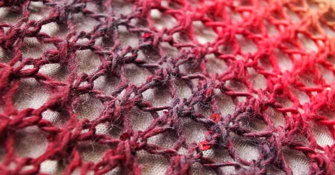 A close up the hexagon grid that is formed by the stitches.