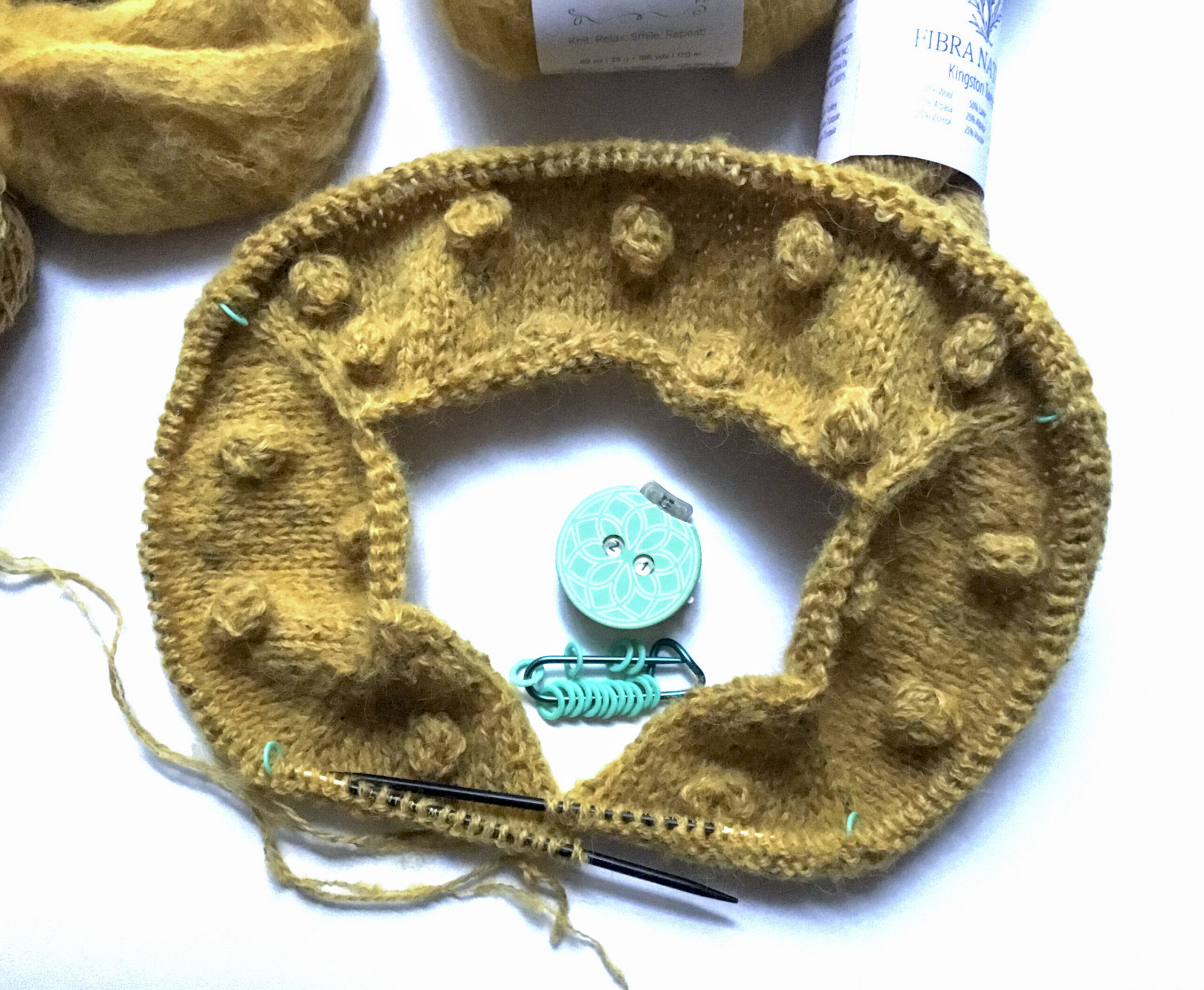 The beginning of the double-stranded top-down bobble cardigan on the circular needles, Knitter’s Pride stitch markers and row counter.