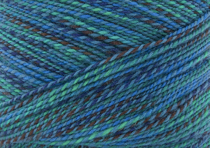 A close-up of a skein of Fibra Natura Cobblestone in the Mallard colorway, which is a marled blue, green and gray