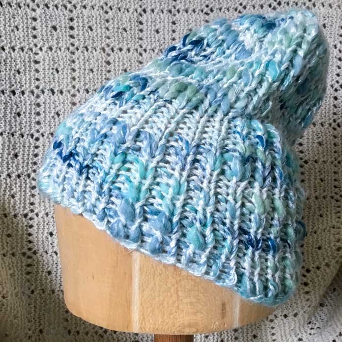 Side view of a hat knitted with two strands of UY Bamboo Bloom Handpaint.