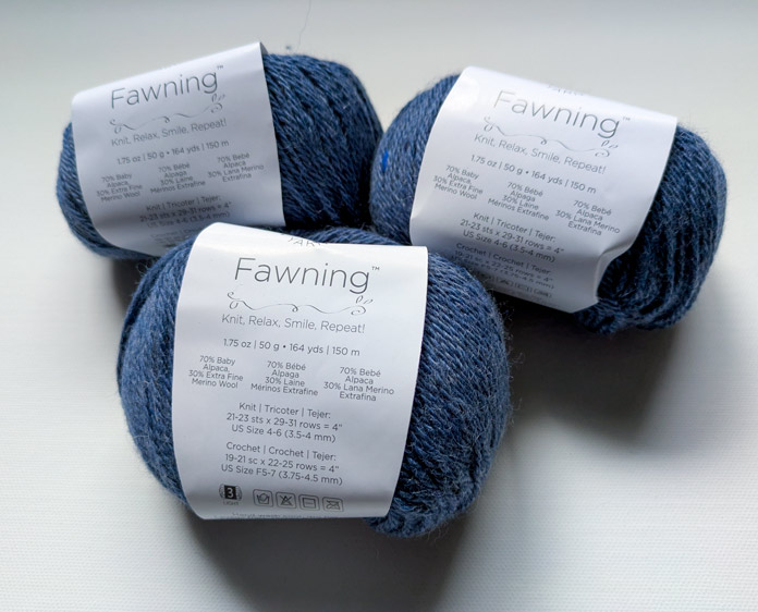 Three balls of baby alpaca and extra fine merino wool blend yarn in a blue-gray color, with labels; Yarn Reviews, UNIVERSAL YARN, Fawning, KNITTER’S PRIDE, LANTERN MOON, free knitting patterns, knitting tutorials, knitting notions, circular needles, sweater knitting