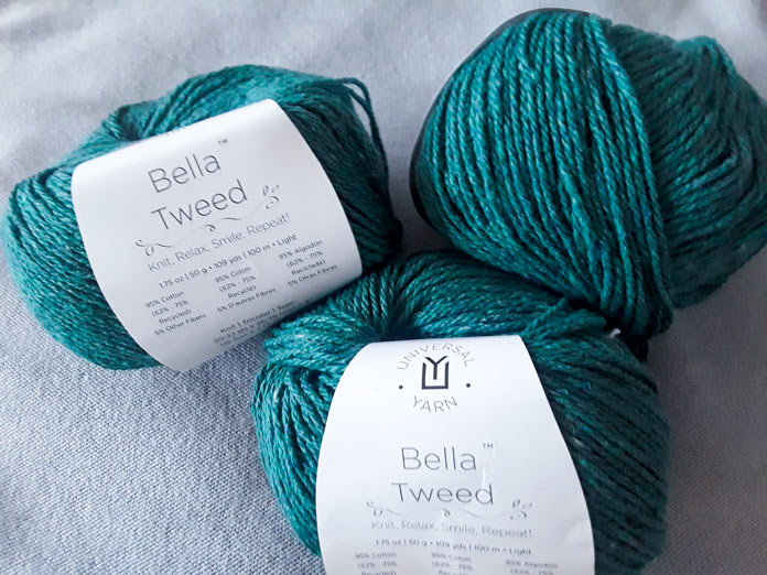 Three 50g skeins of UNIVERSAL YARN Bella Tweed in “Care” colorway