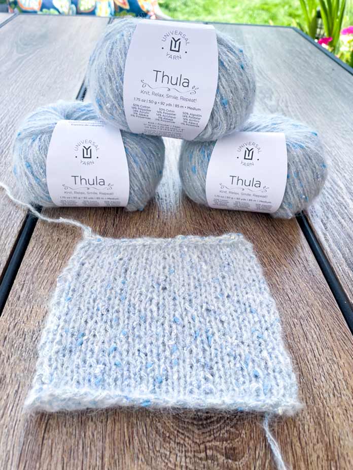 3 balls of UNIVERSAL YARN Thula in the Delphinium colorway to knit the Lace Tipped Cardigan.