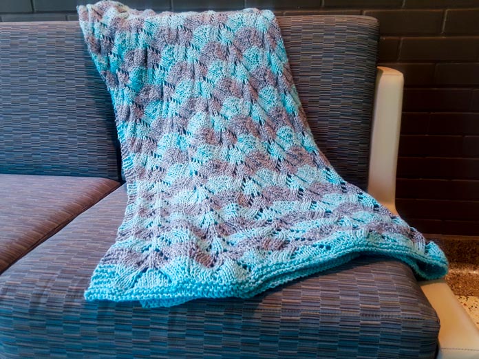 A Finished Sunshine Throw Worsted Blanket knit in two colours of Mystical Marl Yar