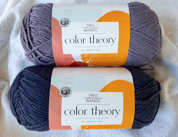 2 skeins of Lion Brand Color Theory in color Amethyst and Admiral