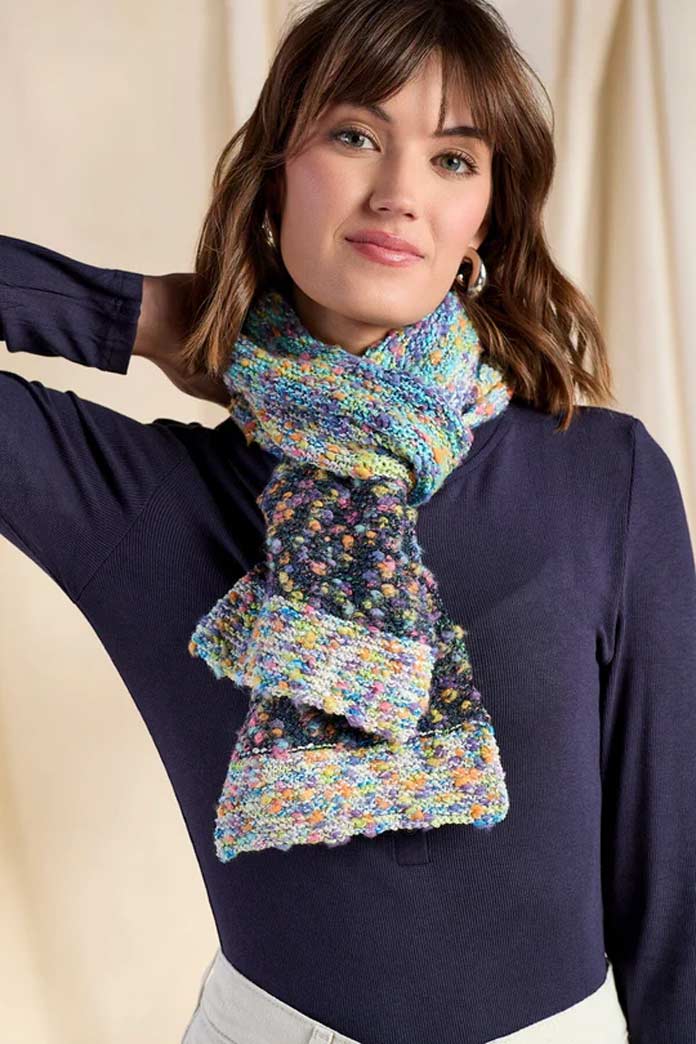 A model wearing a color-blocked scarf using UNIVERSAL YARN Tango