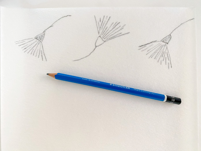 A pencil lying on Sticky Fabri-Solvy with drawn flowers on the stabilizer; Sulky Sticky Fabri-Solvy, DMC floss, DMC Chenille needles
