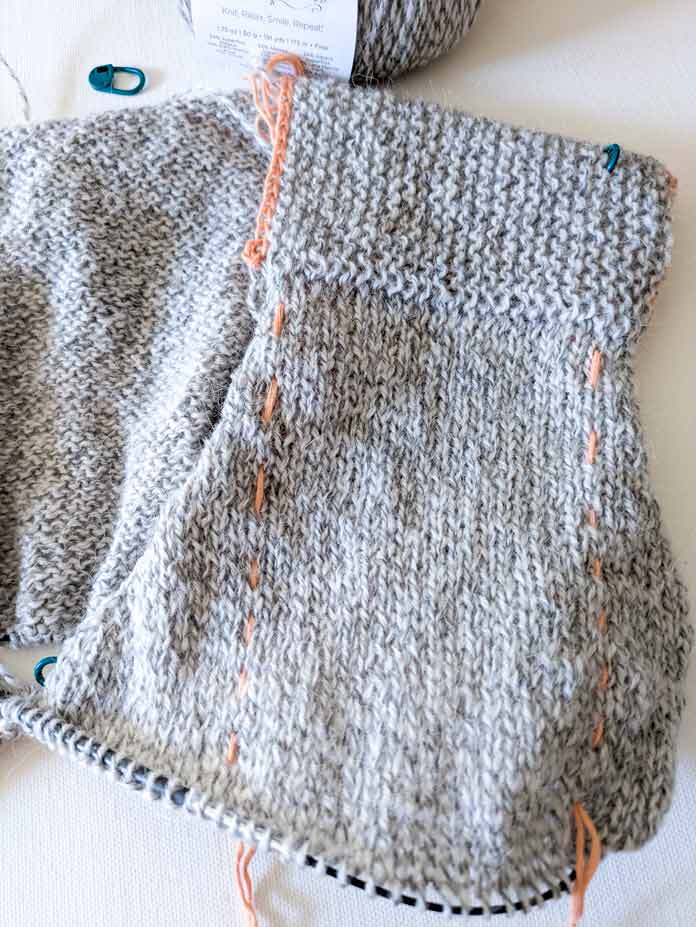 The left front of the cardigan with shaping around the armhole and increases for the V-neck.