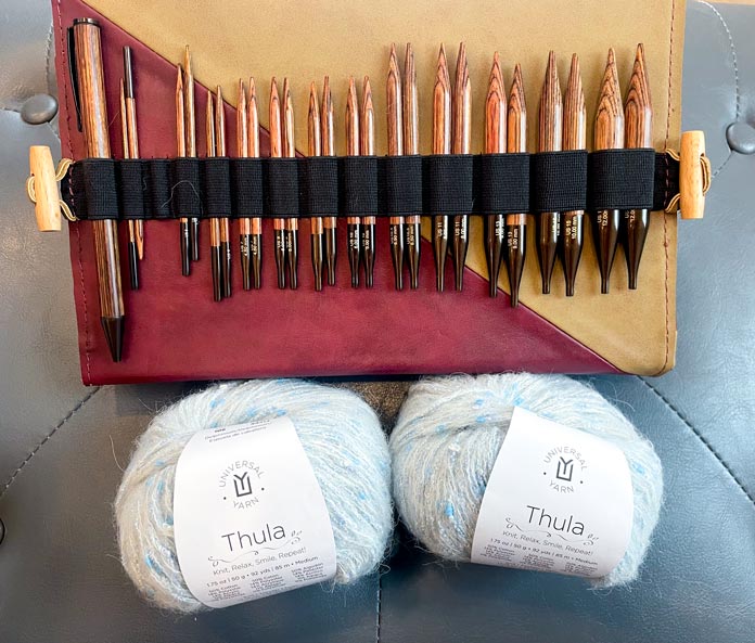Two balls of yarn and a set of interchangeable knitting needles. 