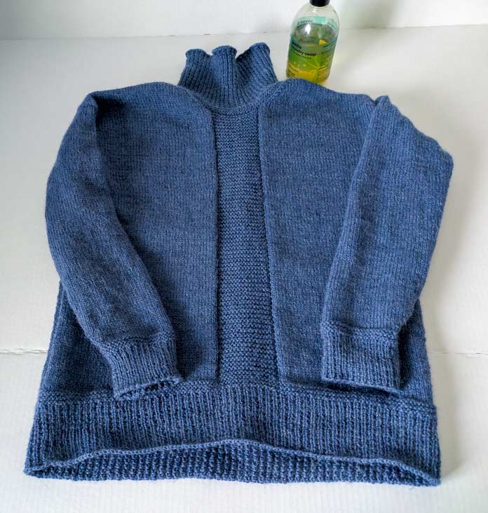 The finished knitted Streamline Pullover and a bottle of Soak wool detergent; Yarn Reviews, UNIVERSAL YARN, Fawning, KNITTER’S PRIDE LANTERN MOON, LANTERN MOON needles, knitting patterns, knitting tutorials, knitting techniques, sweater knitting; SOAK