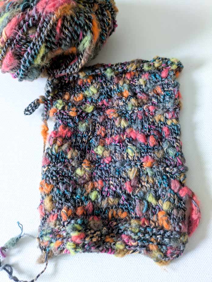A swatch knitted with three different sizes of needles. The needle size is marked on the swatch with yarn overs and purl stitches.