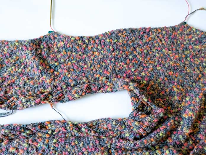 Stitches picked up between the armhole markers using a 2 to 3 ratio for attaching the sleeves to the body.