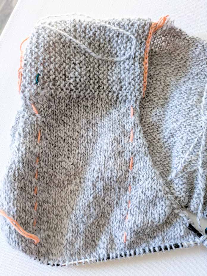 The right front of the cardigan with shaping around the armhole and increases for the V-neck.