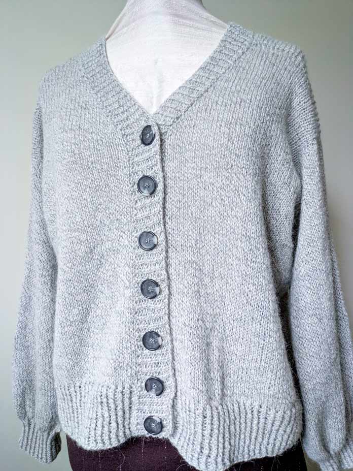 Front view of a V-neck knitted cardigan on a mannequin