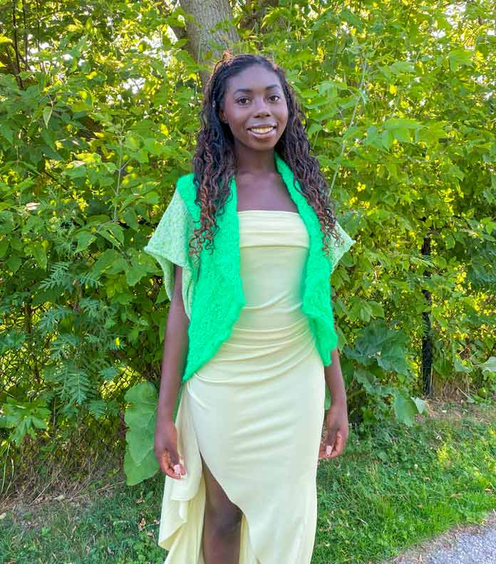 A model wears the finished Lotus Shrug knitted using UNIVERSAL YARN Constellation