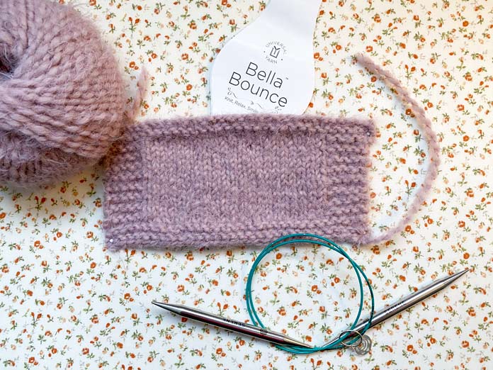 Bella Bounce yarn, a knitted swatch and KNITTER’S PRIDE The Mindful Collection knitting needles