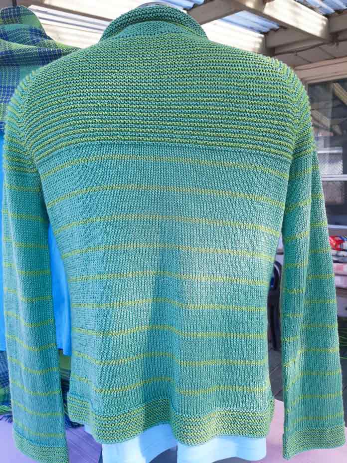 Back view of the Paulie cardigan using Universal Yarn Magnolia in Citrus Leaf and Key Lime colors.