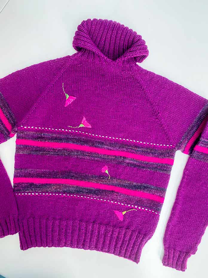 A knitted pullover sporting hand-embroidered flowers; Sulky Sticky Fabri-Solvy, DMC floss, DMC Chenille needles