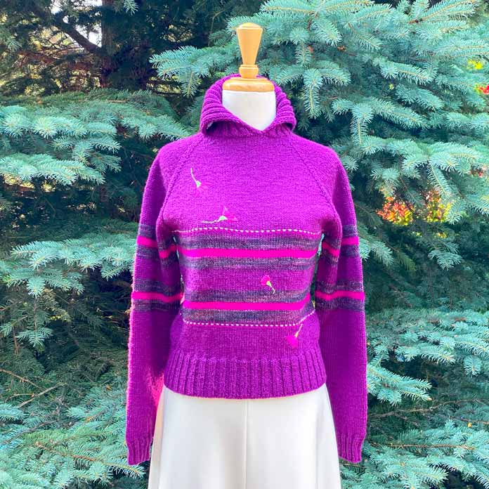 The Experimental Pullover on a mannequin in front of an evergreen