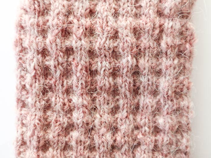 The waffle stitch is easy to do and looks spectacular with the heathered look of Odette. Spiral Toes Waffle Socks by Cindy O’Malley using Universal Yarn Odette