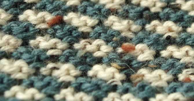 Close up of easy-to-knit houndstooth where tweed nubs are really visible.