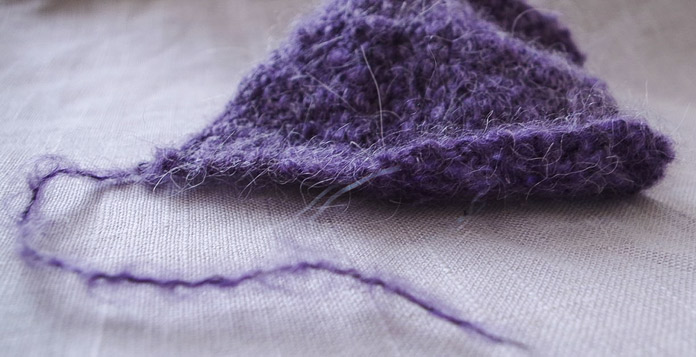 Knit fuzzy yarn for any garment or home decor. The white alpaca in Revolutions lends a certain shimmer to the finished knitting.