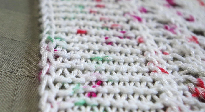 A 2-stitch i-cord edging creates a neat border for the sides of this blanket.