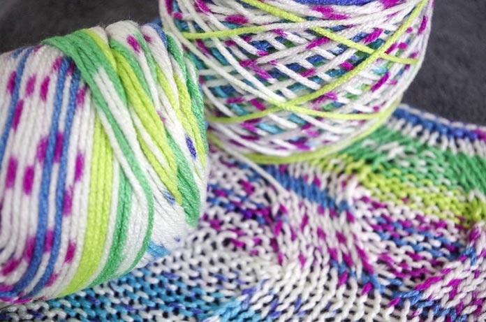 This yarn looks amazing in any format, in the hand, wound into a cake, and knit into a subtly-textured stitch pattern. Using Super Saver Fair Isle yarn to swatch using the twisted make one.