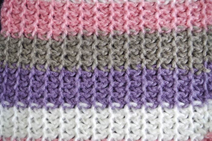 The "private" side of the bi-directional herringbone stitch pattern is equally lovely, with it's splayed columns stitches and slightly crocheted appearance. Using Red Heart Dreamy Stripes