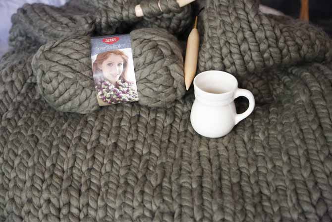 My daughter’s blanket is very soft and textured at the same time. I placed a cup of 11oz to show you how big the ball of yarn is, and how big the knit is too. Red Heart Boutique Irresistible yarn in Taupe