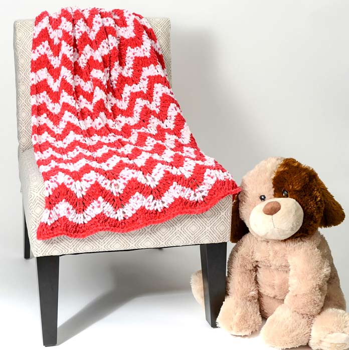 It's easy to find a solid color of Bella Chenille that coordinates with one of the Multi, like the red in this ripple stitch blanket.