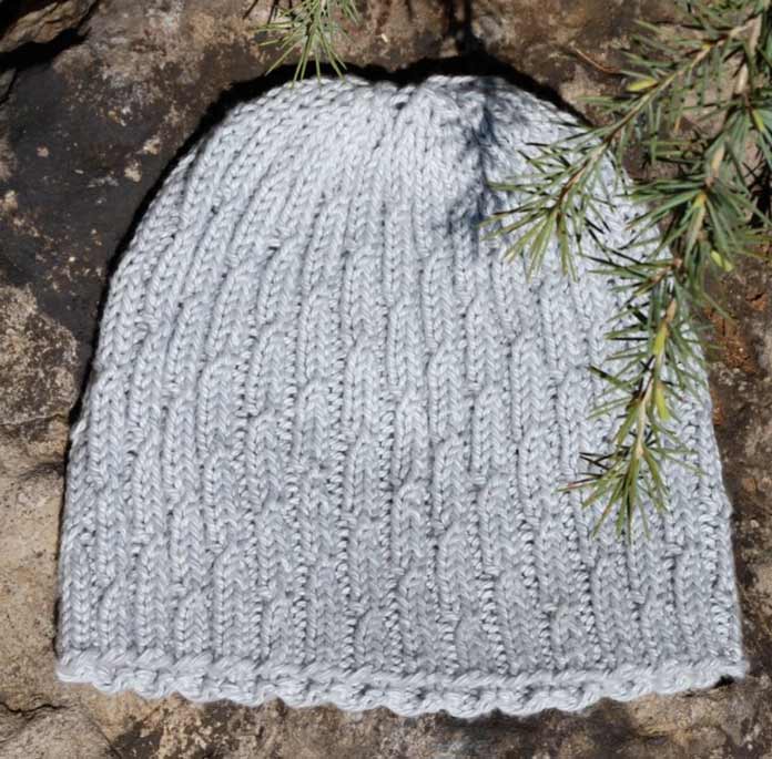 The product photo of the Overcast Cap in a solid grey color. Uptown Worsted Mist is going to be a variegated grey with white. It should look interesting!